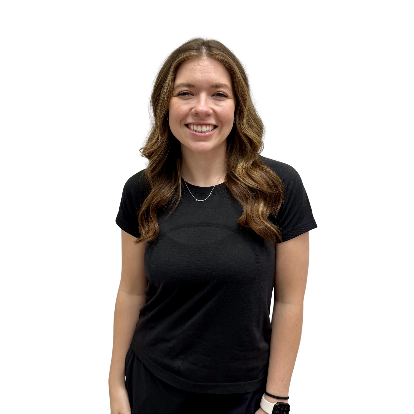 Smiling woman with wavy brown hair wearing a black t-shirt, standing against a white background.